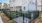 a fenced in green lawn in front of a building